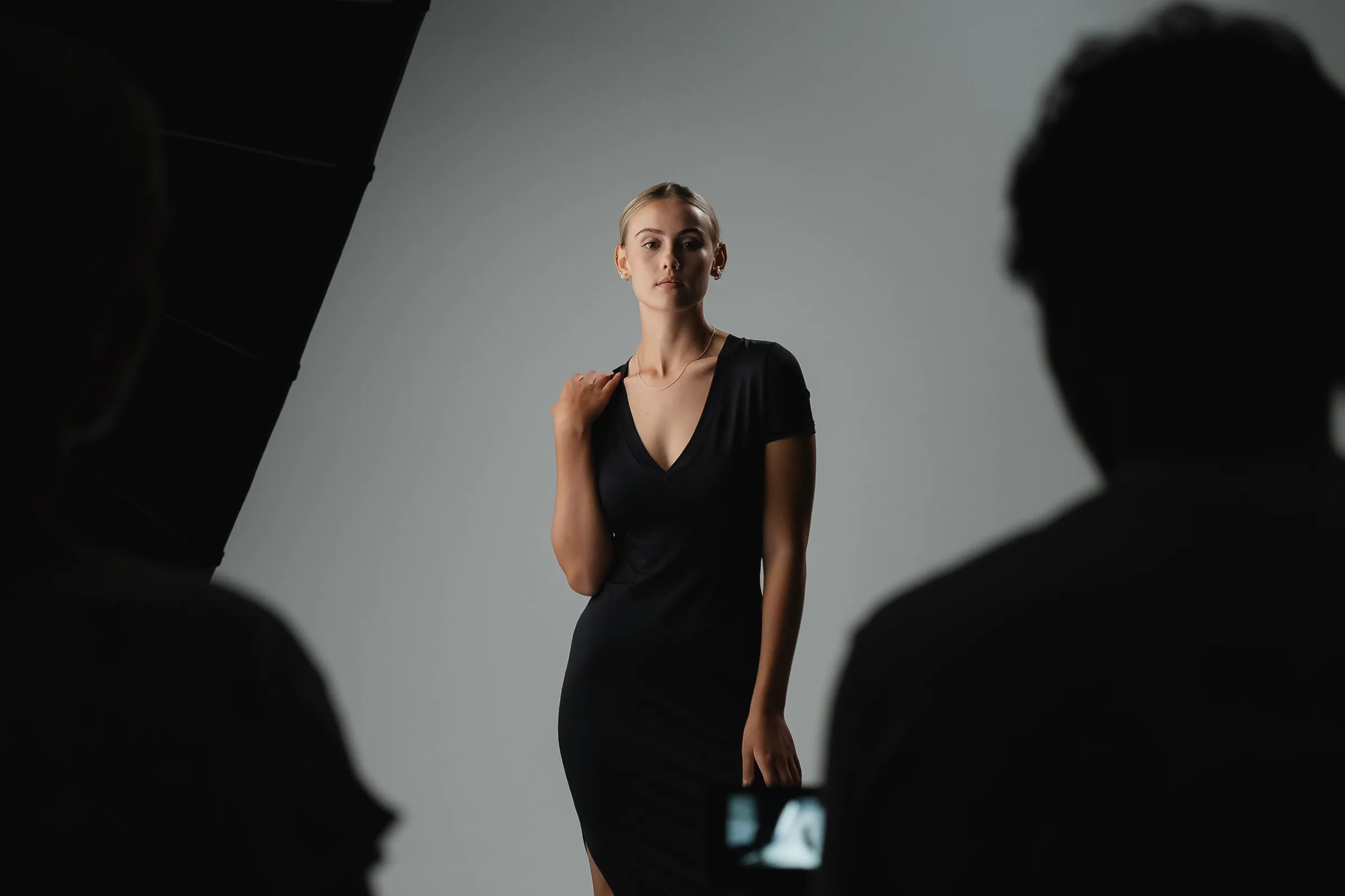 A model in a black dress photographed during a Studio GQ production