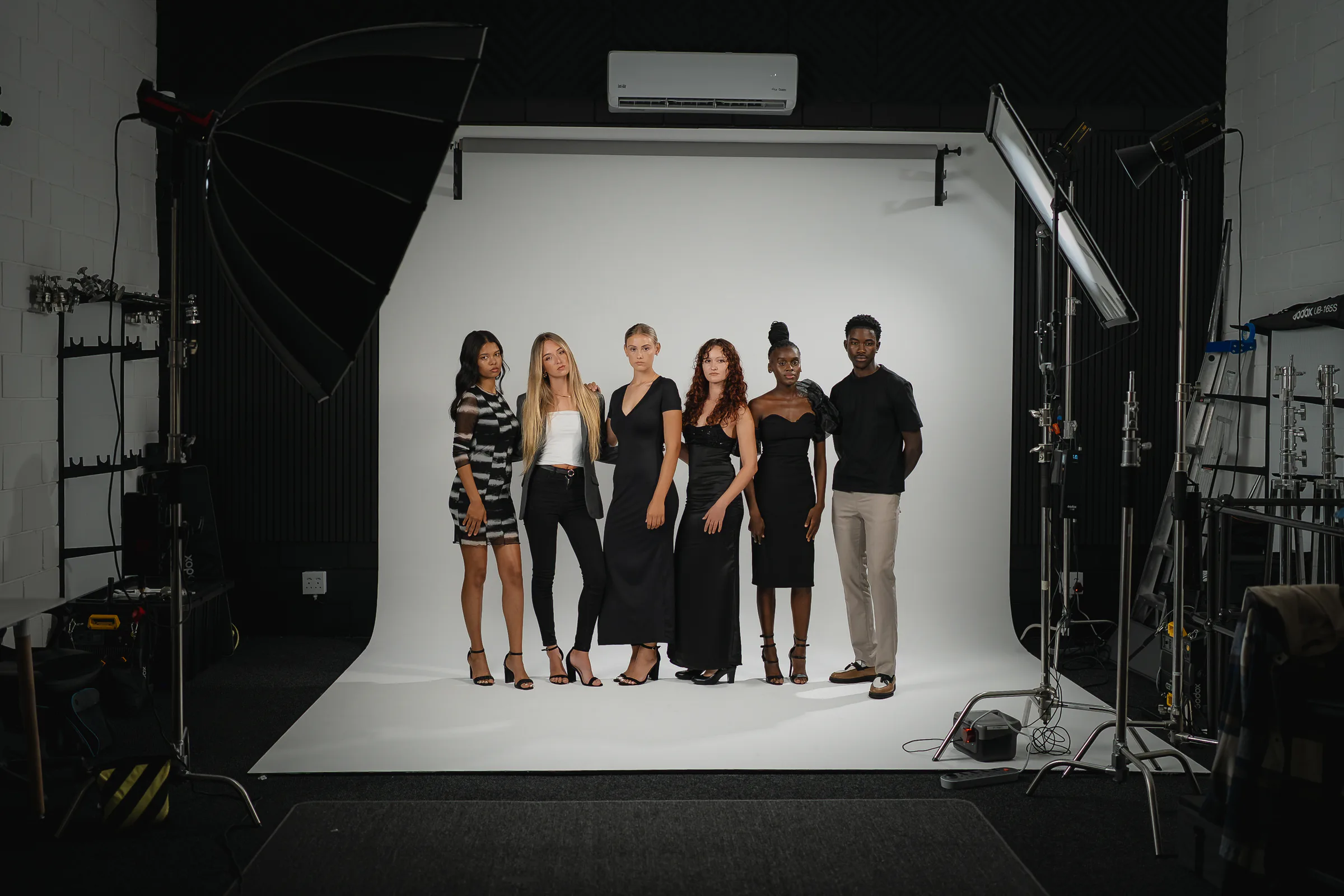Models and production equipment arranged around Studio GQ's infinity curve